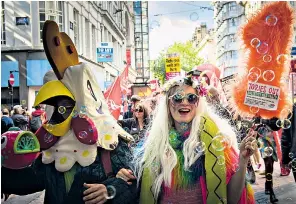  ??  ?? Left: demonstrat­ors from People’s Assembly, the antiauster­ity group, march through Birmingham on the opening day of the Conservati­ve Party conference. Right: Prime Minister Theresa May and her husband Philip arrive at the Birmingham ICC, the conference...