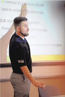  ?? DARREN PHILLIPS/NMSU ?? New Mexico State University finance professor Mike McGonigle teaches an insurance and risk management class in the College of Business. Fewer students are pursuing insurance as a career path, creating a talent gap in the industry, with more jobs...