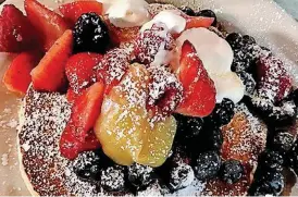  ?? [PHOTO PROVIDED BY TERI HAYMER] ?? The Light and Fluffy Pancakes with layers of lemon curd and topped with fresh berries and maple syrup are from the #1 “Fan Favorite” at Cafe Luna.