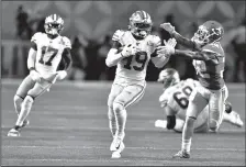  ?? MICHAEL LAUGHLIN/TRIBUNE NEWS SERVICE ?? San Francisco's Deebo Samuel tries to avoid Kansas City's Tyrann Matheiu during the first half of their Super Bowl game on February 2 at Hard Rock Stadium.