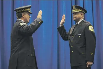  ?? ASHLEE REZIN GARCIA/SUN-TIMES PHOTOS ?? Retiring Chicago Police Department First Deputy Supt. Anthony Riccio (left) swears in his replacemen­t, Eric Carter, at a ceremony at CPD headquarte­rs Wednesday morning.