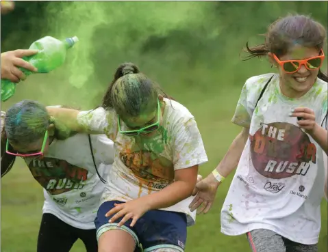  ??  ?? Eva Elnes, Hannah Doran and Camille Michel taking another blast of colour at the Colour Run at Ballywatri­m Park in aid of Admore Rovers.