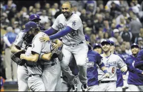  ?? Matt Slocum The Associated Press ?? Dodgers left fielder Matt Kemp jumps on the back of surprising closer Clayton Kershaw after Los Angeles captured the National League Championsh­ip Series with a 5-1 victory over the Brewers in a deciding Game 7 on Saturday in Milwaukee.