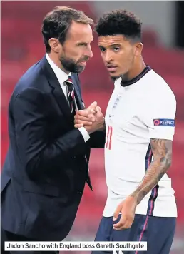  ??  ?? Jadon Sancho with England boss Gareth Southgate