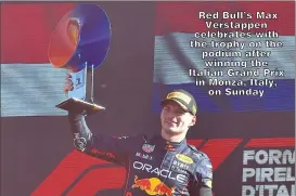  ?? ?? Red Bull’s Max Verstappen celebrates with the trophy on the podium after winning the Italian Grand Prix in Monza, Italy, on Sunday