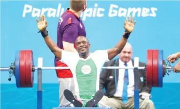  ??  ?? Team Nigeria’s Yakubu Adesokan celebrates winning gold in the men’s -48 kg powerlifti­ng event of the London 2012 Paralympic Games