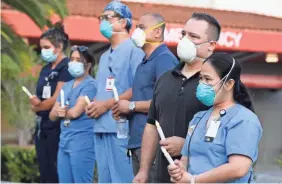  ?? ROBERT HANASHIRO/USA TODAY ?? Nurses in Los Angeles gather for a vigil to honor nurse Celia Marcos, who died two days after testing positive for COVID-19.