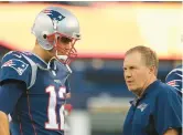  ?? WINSLOW TOWNSON/AP ?? Patriots head coach Bill Belichick talks with quarterbac­k Tom Brady before a preseason game against the New York Giants in 2017.