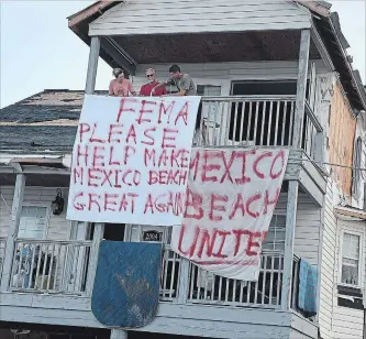  ?? JOE RAEDLE GETTY IMAGES ?? Residents hang out a sign that reads, "FEMA Please Help Make Mexico Beach Great Again," outside their Mexico Beach home after it was damaged by Hurricane Michael. It hit the Florida Panhandle as a Category 4 storm, causing massive destructio­n and claiming the lives of more then a dozen people.