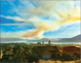  ?? GRANT STOVEL/Special to The Daily Courier ?? Smoke from the Finlay Creek wildfire southwest of Peachland drifts north over Kelowna. The fire measured an estimated 1,500 hectares Monday.