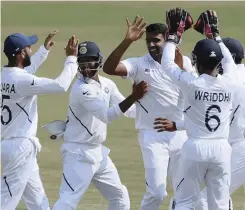  ?? AP PHOTO ?? INDIA spinner Ravichandr­an Ashwin celebrates with team-mates after dismissing South Africa’s Theunis de Bruyn on the fifth day of the first Test on Sunday. |