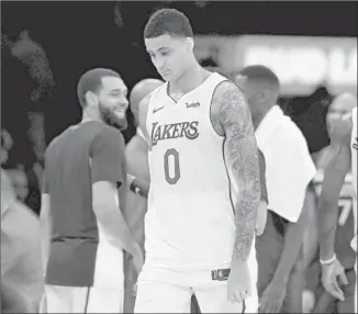  ?? Gary Coronado Los Angeles Times ?? KYLE KUZMA of the Lakers suffered a right quad contusion Wednesday against Memphis and is questionab­le for the game tonight against the Clippers. He shot four of 24 against the Grizzlies.