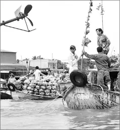  ??  ?? Selling vegetables on a boat in a canal off the Song Hau river.