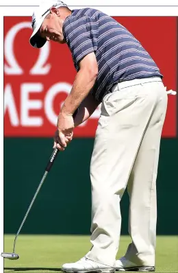  ??  ?? SOLID STROKE: Drysdale putts on the last as he completes a round of 64 yesterday to trail leader Scott Hend by five shots going into the final 18 holes