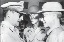  ?? Gamma-Keystone / Getty Images ?? GEN. DOUGLAS MacArthur, left, who’d retreated in 1942, returned in 1945. Here with Philippine President Sergio Osmeña.