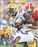  ?? / Atlanta Journal Constituti­on-Bob Andres ?? LSU safety John Battle, with assistance from cornerback Greedy Williams, intercepts a pass from Georgia quarterbac­k Jake Fromm intended for wide receiver Jeremiah Holloman, rear, during the fourth quarter of Saturday’s game in Baton Rouge, La.