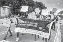  ?? Sunday Alamba / Associated Press ?? Activists march on the streets of Lagos, Nigeria, on Friday demanding action on climate change.