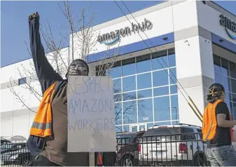  ?? ASHLEE REZIN GARCIA/SUN-TIMES PHOTOS ?? Rakyle Johnson, a sorter, joins about a dozen fellow Amazon workers in a walkout on Wednesday to demand better conditions at the retailer’s Gage Park facility, 3507 W. 51st St.