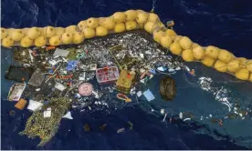  ??  ?? The boom skims up waste ranging in size from a discarded net and a car wheel to tiny chips of plastic. Photograph: AP