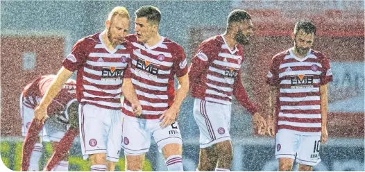  ??  ?? The rain doesn’t bother the Hamilton Accies players after Mason Bloomfield’s late winner earned them all three points