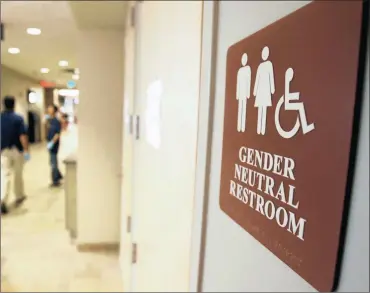  ?? PHOTO: AP ?? A sign marks the entrance to a gender-neutral restroom at the University of Vermont in Burlington, US. The writer says that the late ANC president OR Tambo put the party straight in terms of the role of women when they returned from exile.