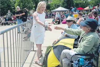  ?? Kelsey Kremer, The Des Moines Register ?? U.S. Sen. Kirsten Gillibrand, D-N.Y., shakes hands with people after speaking at the annual Progress Iowa Corn Feed last Sunday in Cedar Rapids. Her presidenti­al campaign is struggling.