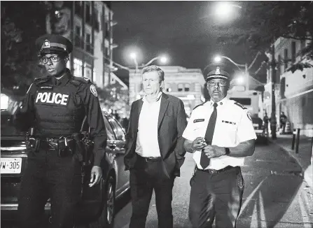  ?? CHRISTOPHE­R KATSAROV THE CANADIAN PRESS ?? Mayor John Tory, centre, and police Chief Mark Saunders, right, address the media following Sunday’s shooting rampage in Toronto.