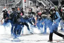  ?? Thanachote Thanawikra­n / Associated Press ?? Thai police and protesters clash Saturday in Bangkok amid demands for Prime Minister Prayuth Chan-ocha to resign.