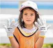  ?? ?? Catherine Jansen, 5, showed off her protective gloves to pick up rubbish – saying ‘‘I keep the sea, Rubbish free’’.