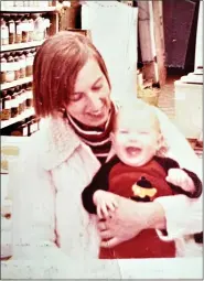  ?? COURTESY MARIEKE CORMIER ?? Second generation Roots owner Marieke Cormier is held by her mother Ellen Jonkers at the family’s first health centered store, Happy Trails in Gardner, circa 1977.