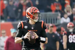  ?? JEFF DEAN — THE ASSOCIATED PRESS ?? Cincinnati Bengals quarterbac­k Joe Burrow (9) looks to throw during the fist half of an NFL football game against the Baltimore Ravens, Sunday, Dec. 26, 2021, in Cincinnati.