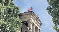  ??  ?? Macclesfie­ld town hall flag flies at half mast to remember those who died in the terror attack