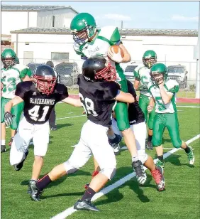  ?? TIMES photograph­s by Annette Beard ?? Freshman Quentin Miller (No. 68) makes a driving tackle to bring down the Greenland ball carrier during the Jr. High benefit scrimmage Monday night.