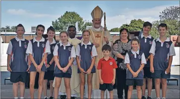  ?? ?? Proud: The St Joseph’s Primary School 2022 Leaders Cooper, Yolanda, Angus, Ruby, Father Vjay, Ayla, Bishop Shane, Lola, Talon and Cael. Also pictured: Foundation student Sam and Principal Mary Dunstan.