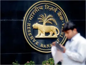  ?? Reuters ?? A man checks his phone outside the Reserve Bank of India headquarte­rs in Mumbai. —