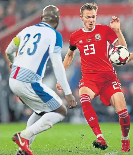  ??  ?? IN THE THICK OF IT: Ryan Hedges, centre, in action for Wales against Panama. The Dons winger has aspiration­s