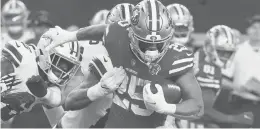  ?? RICHARD RODRIGUEZ/GETTY ?? 49ers running back Elijah Mitchell (25) carries the ball against the Cowboys in Sunday’s wildcard game at AT&T Stadium in Arlington, Texas.