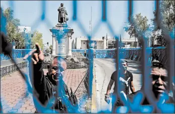  ?? PEDRO PARDO/GETTY-AFP ?? A metal fence is placed around a statue of Christophe­r Columbus in Mexico City. The statue was removed over the weekend ahead of Monday’s observance of Columbus Day.