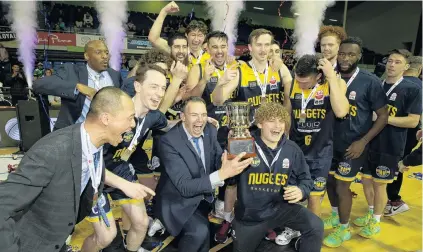  ?? PHOTOS: GETTY IMAGES ?? We are the champions . . . The Otago Nuggets celebrate with the NBL trophy after beating the Manawatu Jets in Saturday’s final in Auckland. Right: Otago Nuggets forward Kane Keil looks to drive past Manawatu Jets forward Tom Vodanovich during the NBL final in Auckland on Saturday.