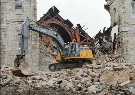  ?? PHOTOS BY DANA JENSEN/THE DAY ?? An excavator works on stabilizin­g the rubble pile Friday as it creates an access route for demolition equipment at the collapsed First Congregati­onal Church in New London. Below, New London fire marshals inspect the site of the church Friday.