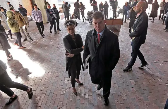  ?? MATT STONE PHOTOS / HERALD STAFF ?? ‘ABUNDANCE OF CAUTION’: Mayor Martin Walsh steps away from the lectern Monday after announcing a temporary ban on constructi­on in the city, which is trying to contain the spread of COVID-19. At top, Walsh listens to Health and Human Services chief Marty Martinez.