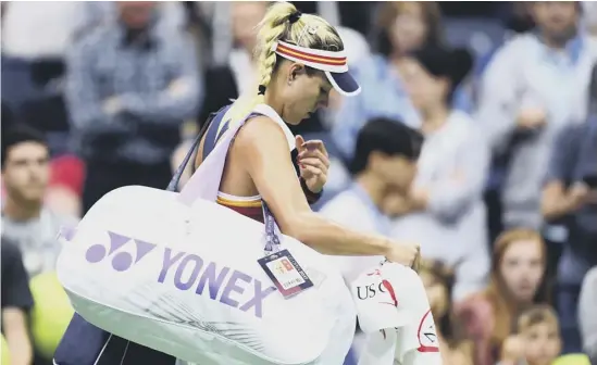  ??  ?? 2 Dejected sixth seed Angelique Kerber leaves the court after suffering a shock 6-3, 6-1 first-round defeat by Naomi Osaka of Japan.