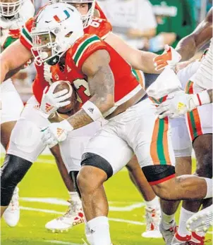  ?? TIM BROGDON/MIAMI ATHLETICS ?? Hurricanes running back Cam’Ron Harris rushes during UM’s final preseason scrimmage ahead of the team’s 2020 opener against UAB.