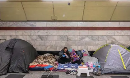  ?? Photograph: Roman Pilipey/EPA ?? Anna and her daughter Sonya sit inside Syrets subway station which is used as a bomb shelter, as Russia's attack on Ukraine continues, in Kyiv, Ukraine, on 18 March.