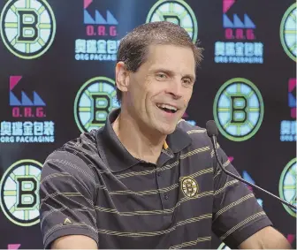  ?? STAFF PHOTO BY NANCY LANE; STAFF FILE PHOTO BY JOHN WILCOX (BELOW) ?? WORTH THE WAIT: Don Sweeney smiles while meeting the press yesterday after announcing the Bruins had signed restricted free agent forward David Pastrnak (below) to a six-year contract worth $40 million.