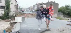  ?? — AFP ?? An elderly woman is evacuated at Villegailh­enc in the Aude region.