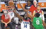  ?? David Becker Associated Press ?? DRAYMOND GREEN shoots over Nigeria’s Ekpe Udoh during a pre-Olympic exhibition game.