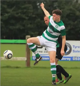  ??  ?? Danny Carroll of Shamrock Rovers tries to hold off the challenge of Ger Carey.