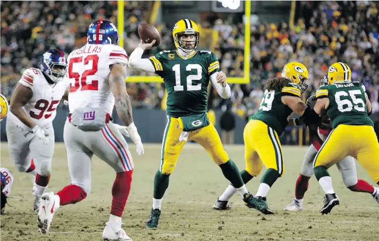  ?? — THE ASSOCIATED PRESS ?? Green Bay QB Aaron Rodgers throws one of four touchdown passes during Sunday’s 38-13 win over the Giants in the NFC wild-card game at Lambeau Field.
