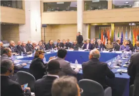  ?? Mandel Ngan / AFP / Getty Images ?? U.S. Secretary of State John Kerry (center, rear) and Italian Foreign Minister Paolo Gentiloni (on Kerry’s left) hosted the conference in Rome.